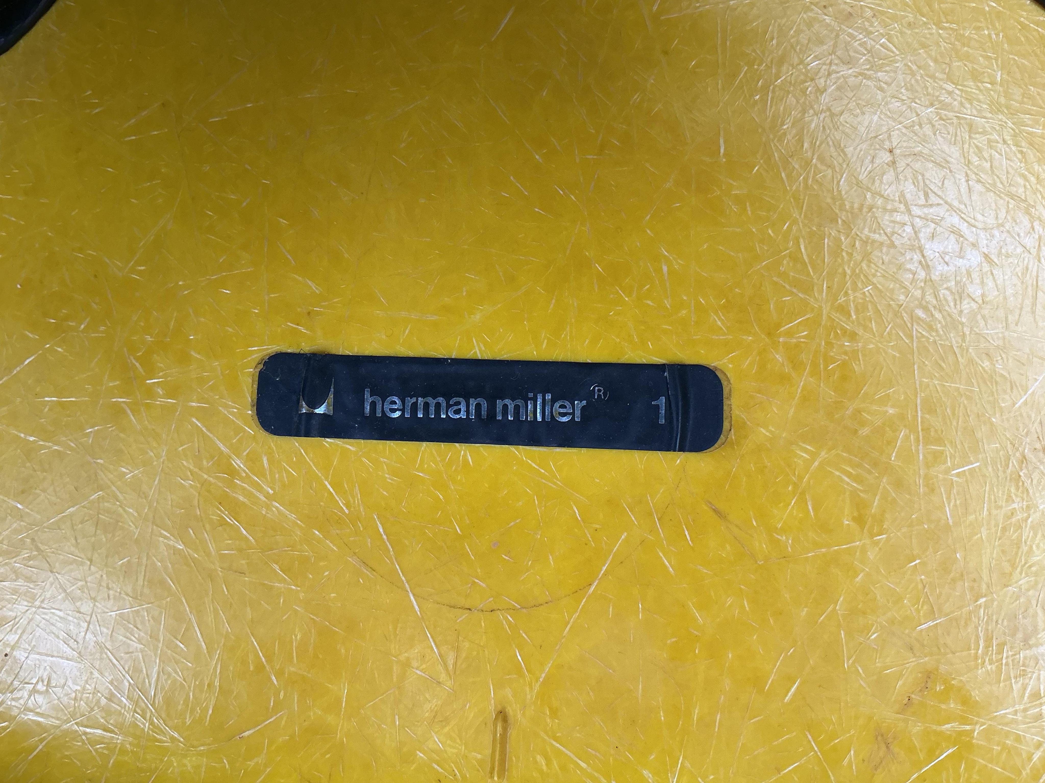 A set of four yellow and chrome Eames shell chairs, width 58cm, height 80cm